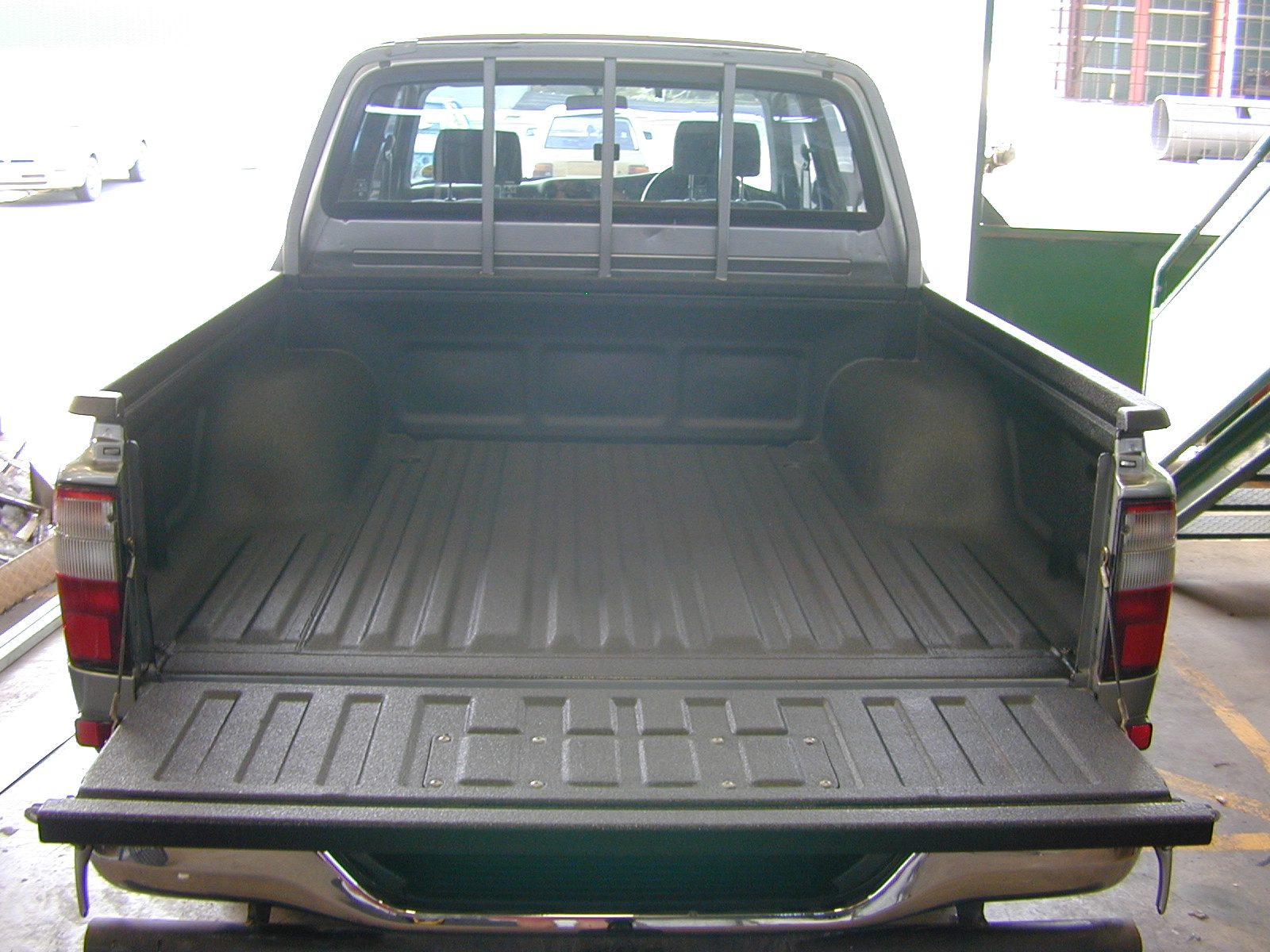 Manufactured steel component with factory-applied protective membrane